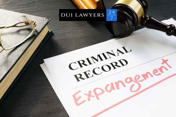 a criminal record expungement form and gavel on a desk