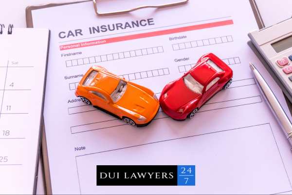 model cars and a blank car insurance form on a clipboard